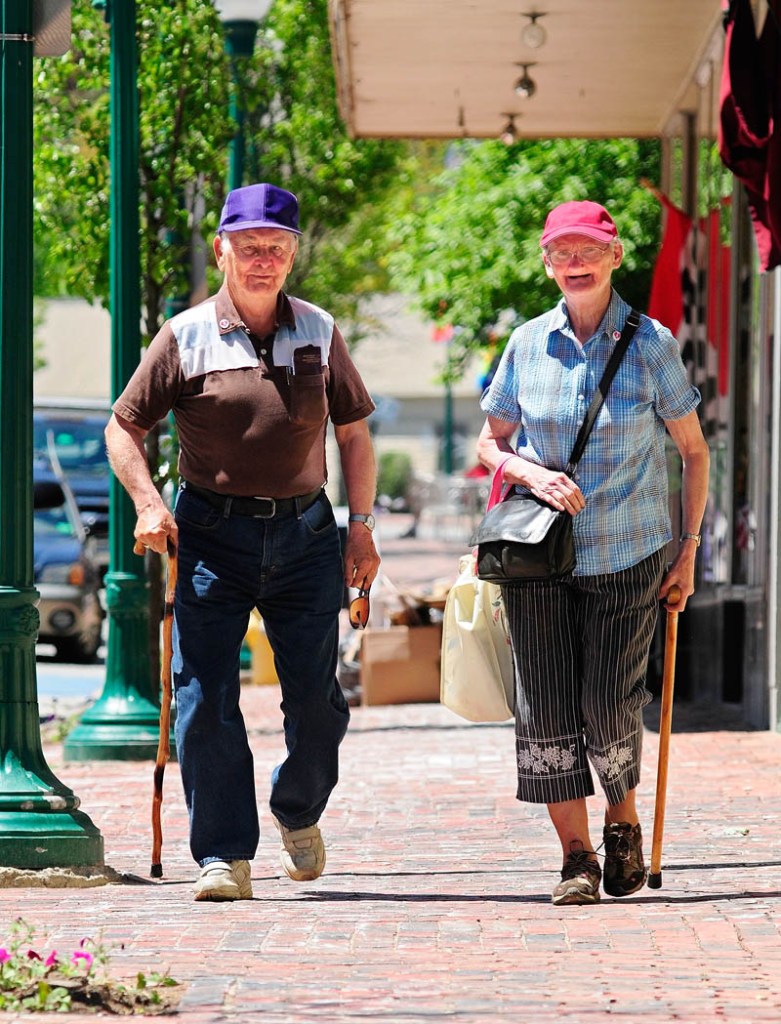 Albert and Elizabeth Conary walk down Water Street on Wednesday in downtown Gardiner. The couple has been married 41 years and most days they walk around the downtown district.