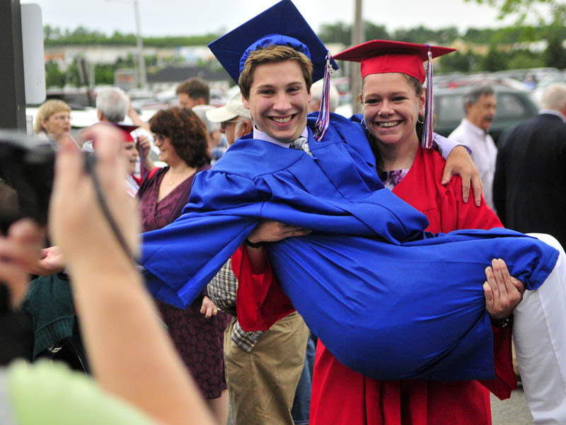 Collin Fosnough, left, poses for a photo with class mate Kaitlyn Davis holding him before Messalonskee graduation on Thursday at the Augusta Civic Center.