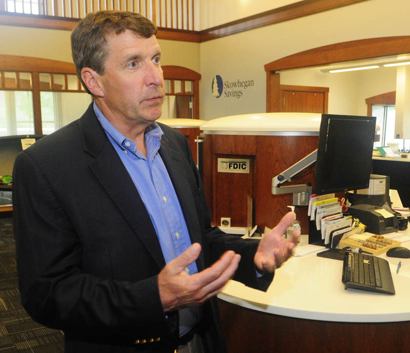 President John Witherspoon talks about Skowhegan Savings' new dialog banking system on Friday in the bank's new branch on Route 27 in Augusta.