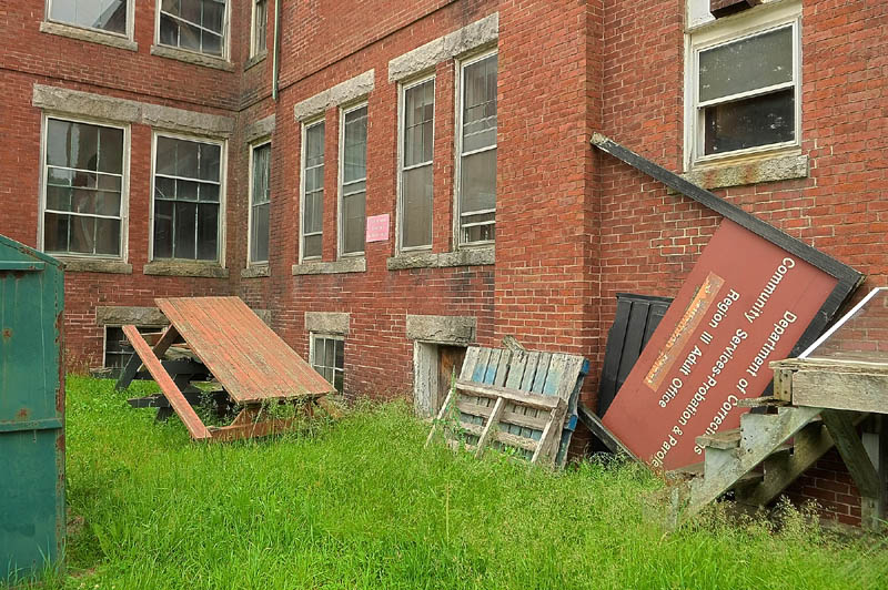 Broken picnic tables and signs are stored behind 7 Beech St., in the old Stevens School complex, on Friday in Hallowell.
