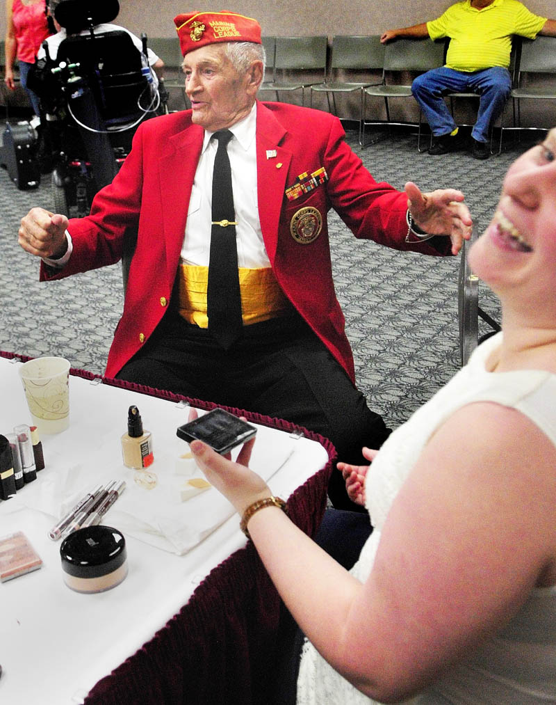 Makeup artist Kathryn Raymond, right, laughs as Leroy Peasley jokes around after she finished his makeup on Friday, before the VA Maine Healthcare Systems-Togus' Creative Arts Festival at the Augusta Civic Center. Peasley, an 89-year-old Marine veteran of World War II from Rockland, was going to read a poem and sing a song during his three-minute slot in the show.