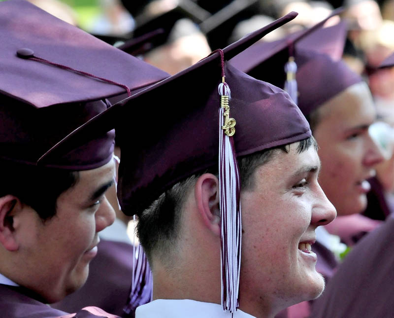 Maine Central Institute graduate Alex Weeman, center, smiles during commencement in Pittsfield on Sunday.