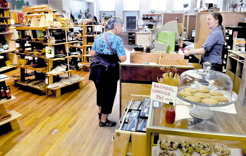 Barrels Community Market employee Suzanne Menair, right, speaks with customer Maggie McKinney at the downtown Waterville store. The business has grown enough that it will become independent of the Main Street Waterville organization that assisted its development.