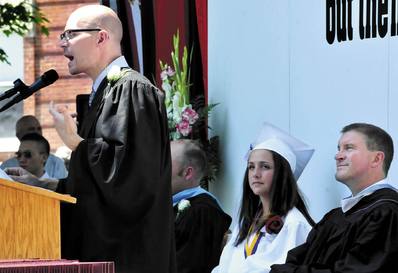 Staff photo by David Leaming KINDNESS: Maine Central Institute commencement speaker Michael Chase, creator of the Kindness Center, delivered his message to graduates in Pittsfield on Sunday, June 2, 2013. At right is valedictorian Brittany Seekins and Headmaster Christopher Hopkins.