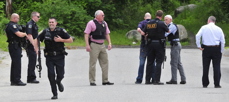 Waterville police take a Toward Street man into protective custody Monday after he threatened to kill himself with a gun. Police said the man, fourth from right, faced no criminal charges and would not identify him.