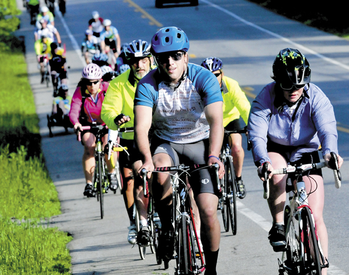 Cyclists are seen along the China Road in China during the third day of the American Lung Association's 29th annual Trek Across Maine fundraiser on Sunday. The riders were en route to Belfast after leaving Waterville.