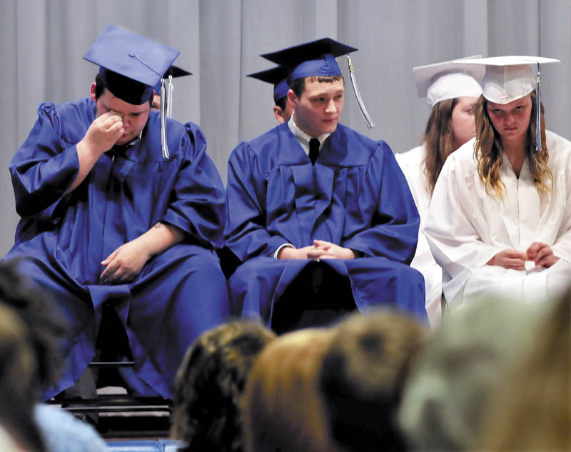 Upper Kennebec Valley Memorial High School student Trevor Beane wipes away a tear while listening to speakers fondly talk about the 13-member graduating class during commencement on Sunday in Bingham.