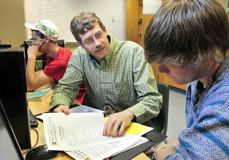 Troy Frost, co-director of the Maine Academy of Natural Sciences, on Thursday speaks with students Keifer Schulz, right, and Jonathon Mullen. Frost is one of five Mine educators to receive the Commissioner's Recognition Awrad from the Department of Education.