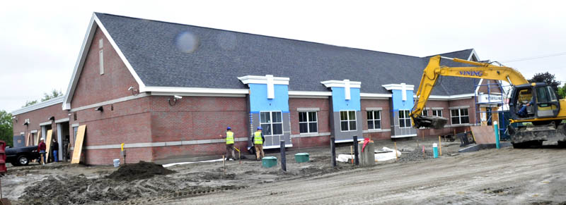 Workers construct the outside of the new Waterville police station on Colby Circle on Wednesday.