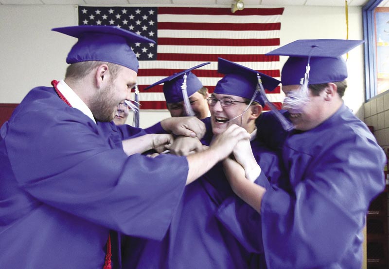 Richard Miller, center, gets a little tough love from Zakkary Bates-Moody, left, and several other friends before commencement exercises begin at Madison Area Memorial High School on Friday night.