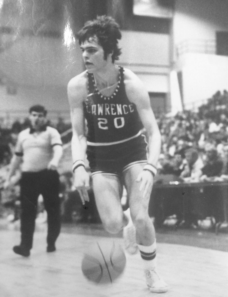 HALL OF FAME CAREER: Mike McGee dribbles up the court during the 1976 state championship game against Rumford at the Augusta Civic Center. McGee, who recently retired after a long career as the Lawrence High School basketball coach, will be inducted into the New England Basketball Hall of Fame for his playing career at the school.