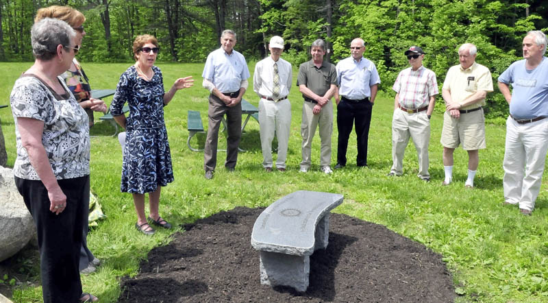 Waterville Rotary Club President Suzanne Uhl-Melanson gestures while dedicating a sitting bench in honor of the years of community service from the Willard B. Arnold family, at the Quarry Road Recreation Area in Waterville on Monday. The Arnold family has been involved with the club and local efforts since 1918. Bill Arnold was unable to attend the dedication.