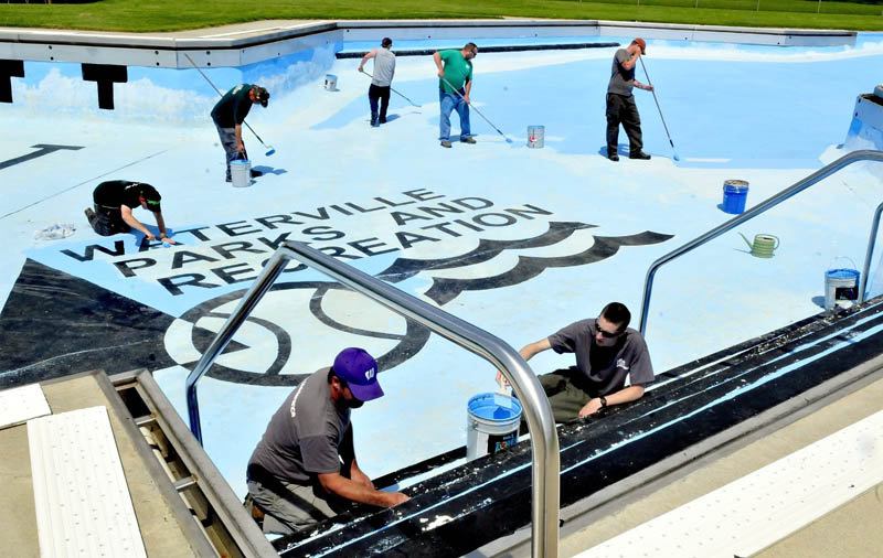 Waterville Parks and Recreation department employees including Sam Green, left, and Nate Bernier paint the large pool on North Street on Monday. The pool is scheduled to open June 22.