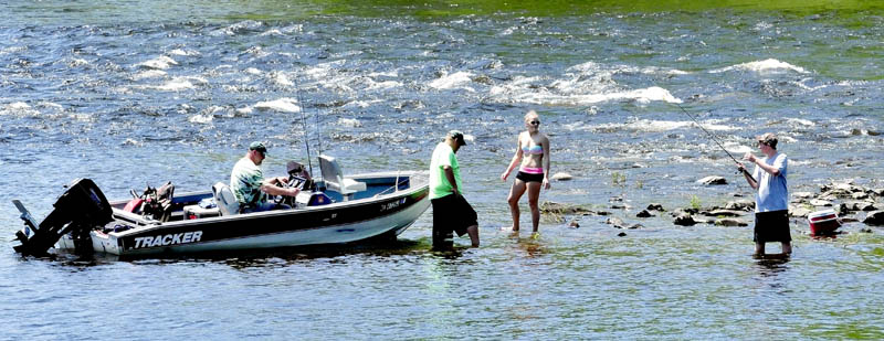 Some people may complain about the recent heat and humidity but these folks, armed with boat, fishing rods, bathing suit and a cooler, took advantage of summer conditions on the Kennebec River in Skowhegan on Sunday.