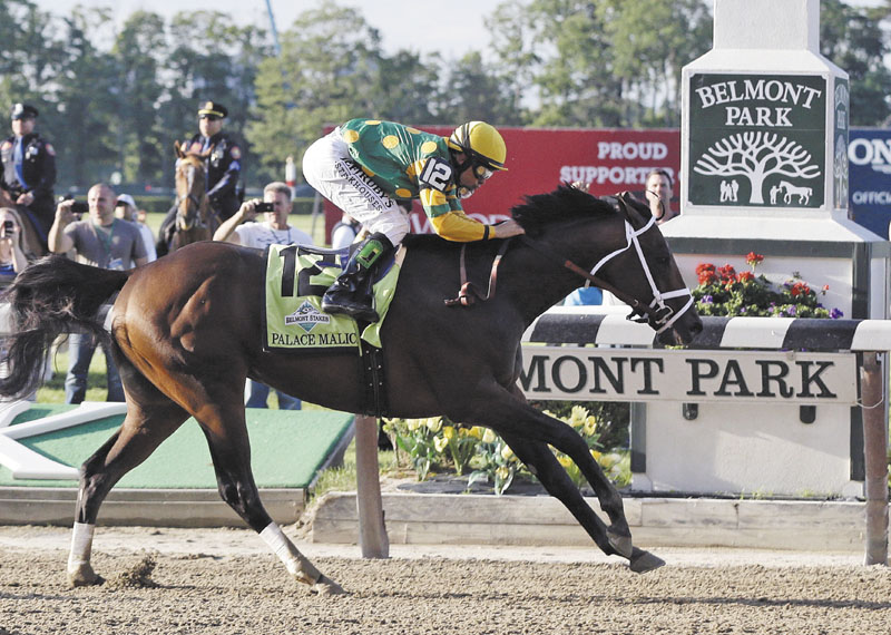 AND THE WINNER IS: Palace Malice, ridden by jockey Mike Smith, crosses the finish line to win the 145th Belmont Stakes on Saturday at Belmont Park in Elmont, N.Y.