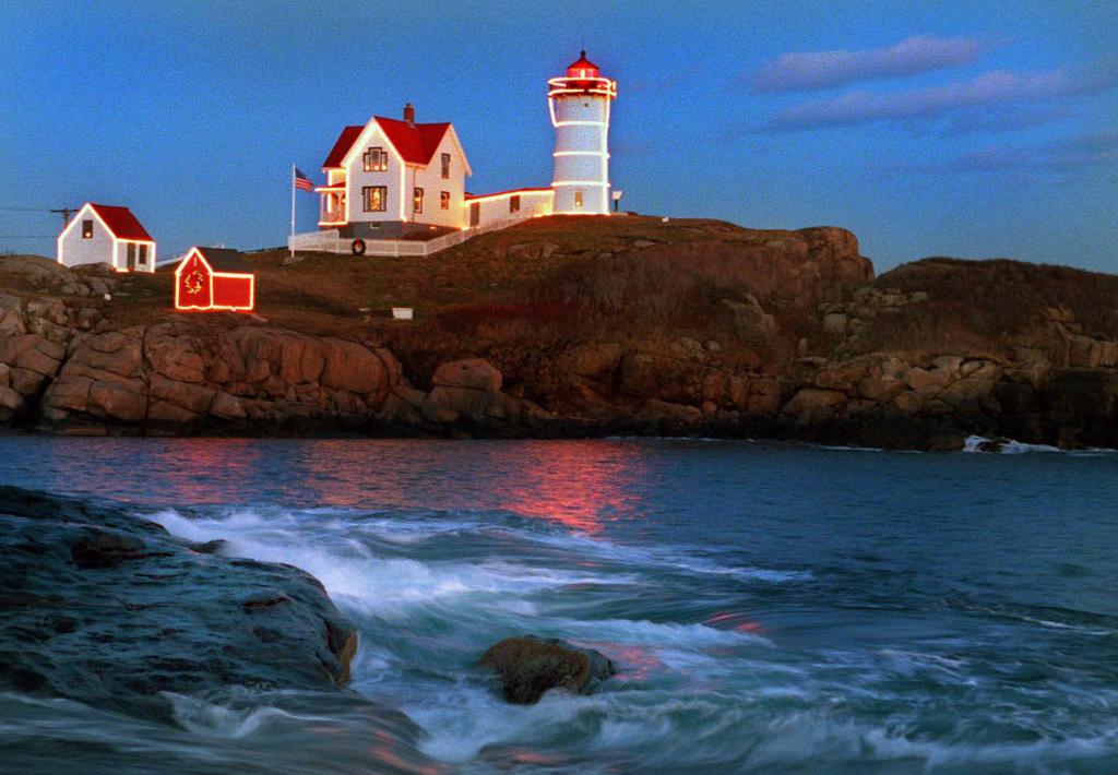 Nubble Light in York is illuminated by Christmas lights as the sun sets on Nov. 28, 1999.
