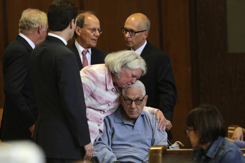 Anthony Marshall, 89, the son of deceased philanthropist Brooke Astor, is kissed by his wife, Charlene, as he arrives with his attorneys in a New York court on Friday.