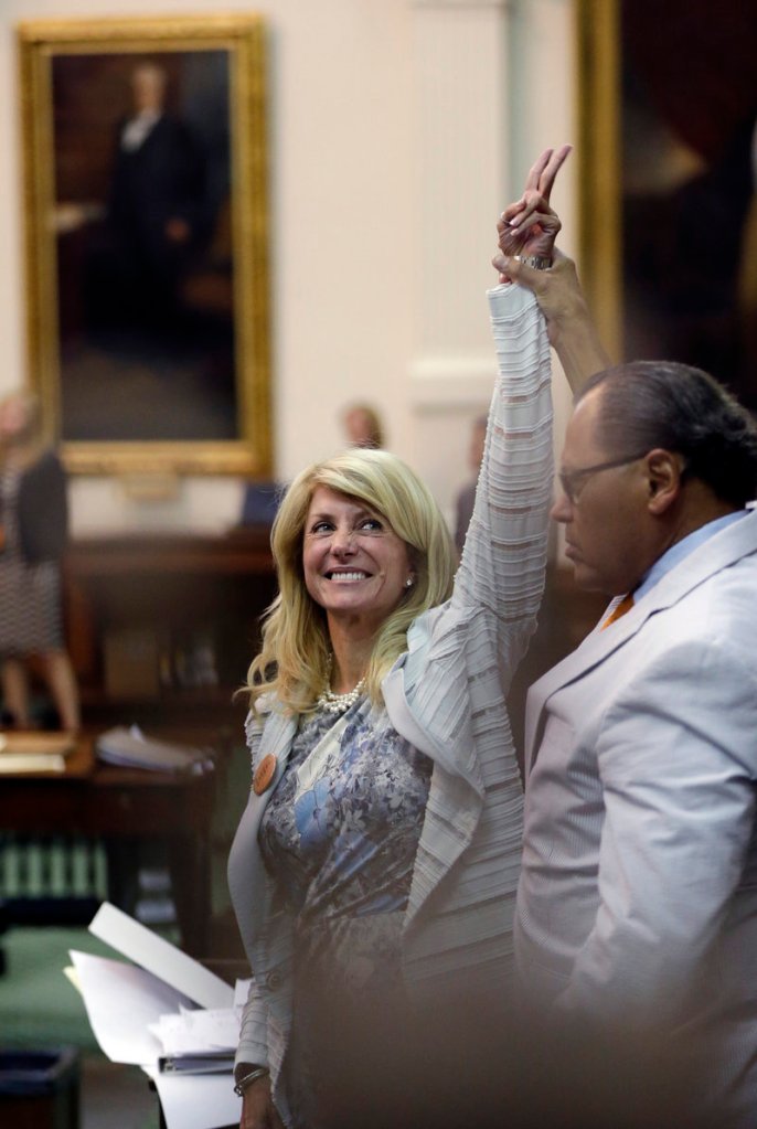 Sen. Wendy Davis, D-Fort Worth, reacts as time expires for a vote on proposed abortion restrictions early Wednesday in Austin, Texas. She delivered a filibuster for 13 hours, supported by hundreds of onlookers.