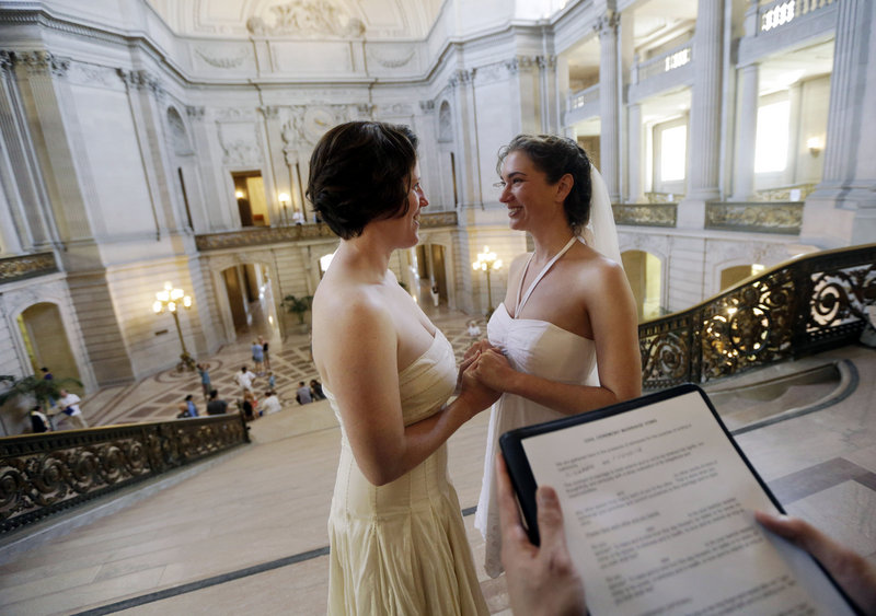 Cynthia Wides, right, and Elizabeth Carey are wed Saturday at City Hall in San Francisco. City officials say 81 same-sex couples married in San Francisco on Friday, within hours of the court decision that lifted the ban.