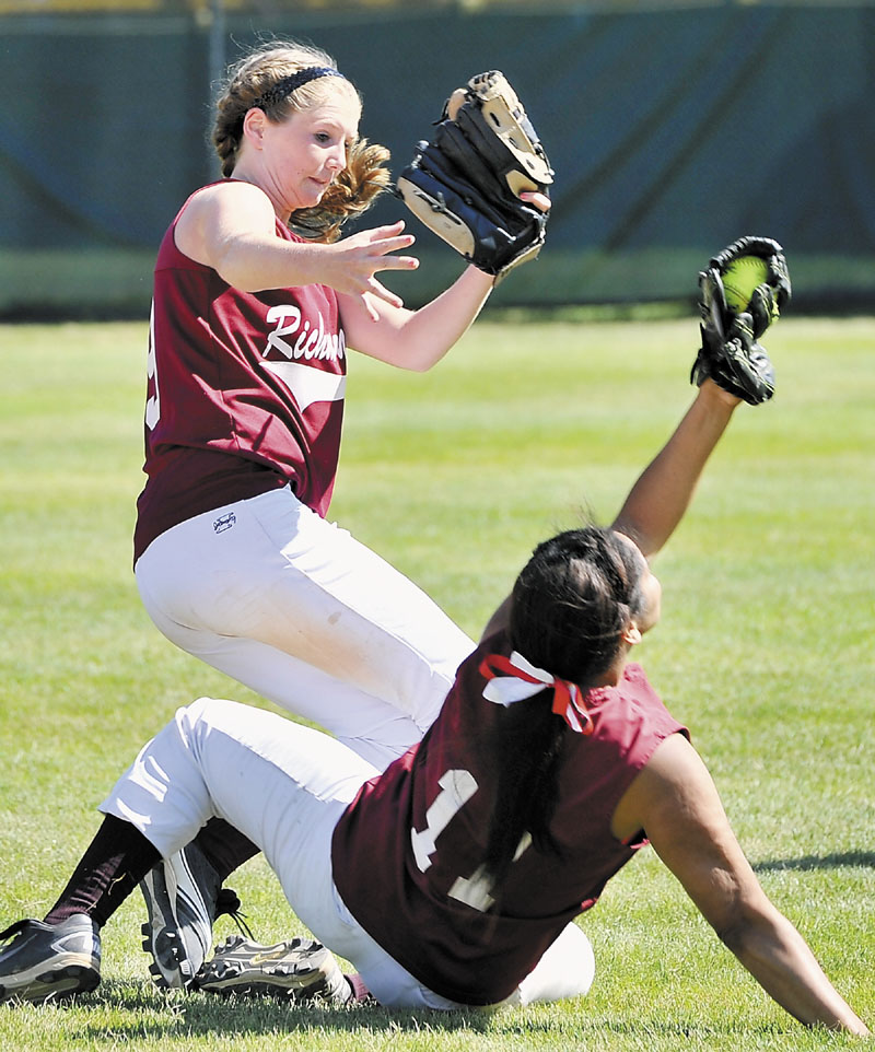 Richmond second baseman Kelsey Anair, left, and first baseman Kelsie Obi collide chasing a pop fly but Obi comes up with the catch during the Class D softball state championship game Saturday in Standish.