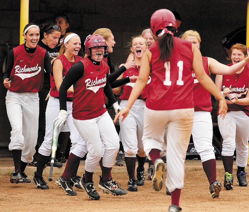 Richmond's Payton Johnson, third from left in batting helmet, celebrates after she scored the Bobcat's 12th run on groundout by Kelsie Obi, 11 center, in fifth inning to win the Western Maine Class D softball championship 12-0 on Thursday at Richard M. Bailey Field at St. Joseph's in Standish.