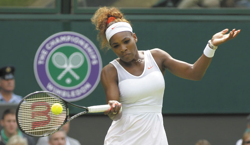 FAST START FOR SERENA: Serena Williams returns a shot to Mandy Minella during their first-round match Tuesday at the All England Lawn Tennis Championships in Wimbledon, London. Williams cruised to a 6-1, 6-3 win.