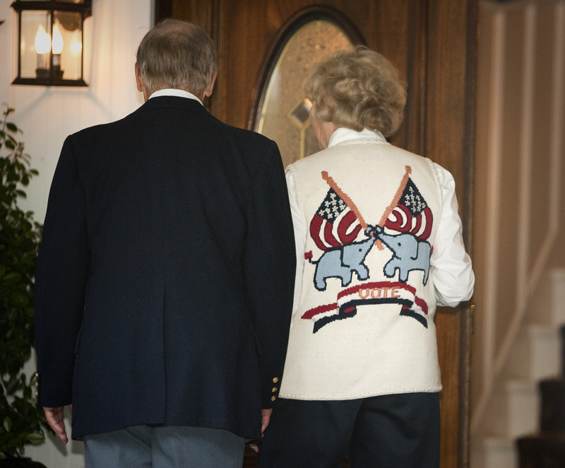 Attendees, including one wearing a Republican-themed sweater, walk into a private fundraiser for Gov. Paul LePage at the Nonantum Resort in Kennebunkport on Tuesday.