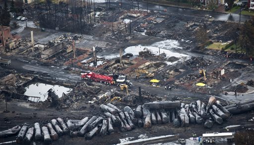 Workers comb through the wreckage Tuesday in Lac-Megantic, Quebec.