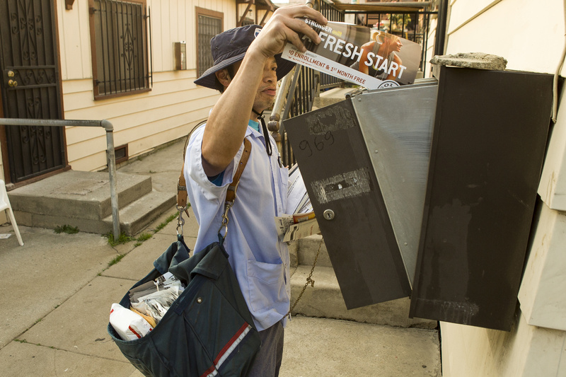 A U.S. mail carrier delivers mail in Los Angeles. The financially struggling U.S. Postal Service may consider phasing out door-to-door delivery.