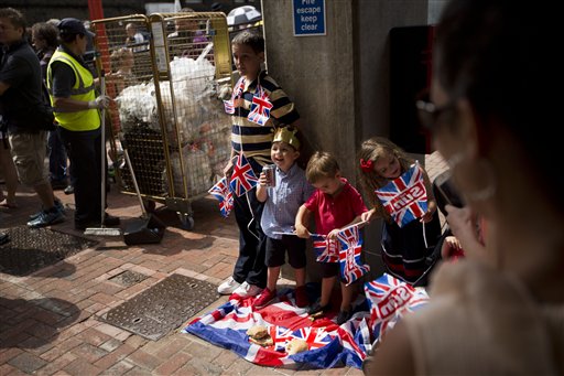 Children have an impromptu picnic as supporters await the departure of Britain's Prince William, Kate, Duchess of Cambridge, and the Prince of Cambridge, outside the entrance of the private Lindo Wing at St. Mary's Hospital in London on Tuesday.