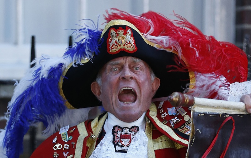 Tony Appleton, a town crier, announces the birth of the royal baby, outside St. Mary's Hospital exclusive Lindo Wing in London, Monday. Palace officials say Prince William's wife, Catherine, has given birth to a baby boy. The baby was born at 4:24 p.m. and weighed 8 pounds 6 ounces. The infant will become third in line for the British throne after Prince Charles and William.