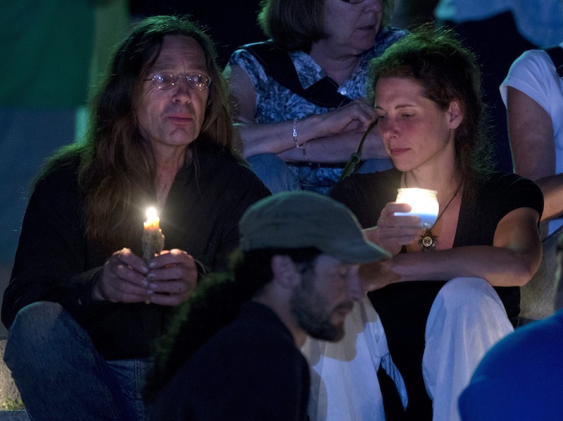 People gather in front of the St-Agnes church during a vigil for the victims of the train crash in Lac-Megantic, Quebec, Friday, July 12, 2013. Transportation workers moved carefully Friday in and around the site of the nearly week-old derailment that incinerated the heart of this small Quebec town and killed 50 people, searching for evidence that would help explain what led to such massive destruction. (AP Photo/The Canadian Press, Jacques Boissinot) Canada;Quebec;Montreal;transportation;business;Canadian;economic;economy;industry;move;ship;shipping;transit;transport;travel industry;commerce;tourism;fire;train;rail;derail;tragedy;disaster