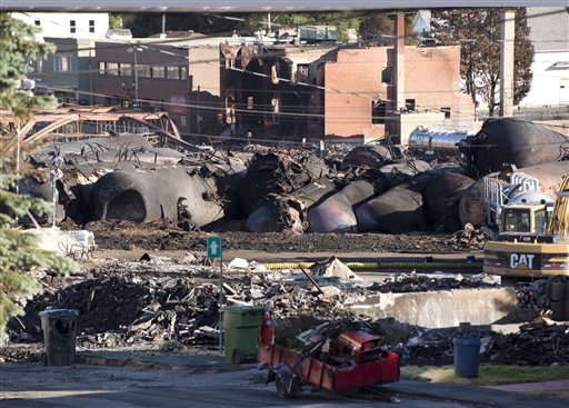 Charred tanker cars from the train crash scene remain in Lac-Megantic, Quebec, on Friday. Transportation workers moved carefully Friday in and around the site of the nearly week-old derailment that incinerated the heart of this small Quebec town and killed 50 people, searching for evidence that would help explain what led to such massive destruction.