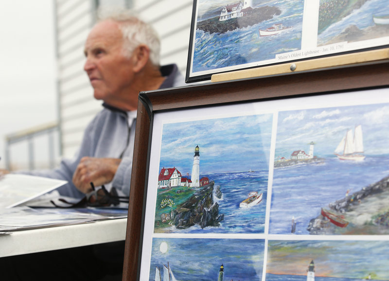 Bill Thomson of Kennebunk sells his paintings of Portland Head Light at Fort Williams Park on Tuesday, July 9, 2013.