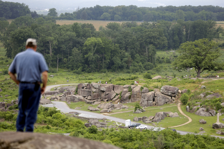 Tim Jenkins of Virginia views the Devil's Den from Little Round Top during ongoing activities commemorating the 150th anniversary of the Battle of Gettysburg on Monday in Gettysburg, Pa.
