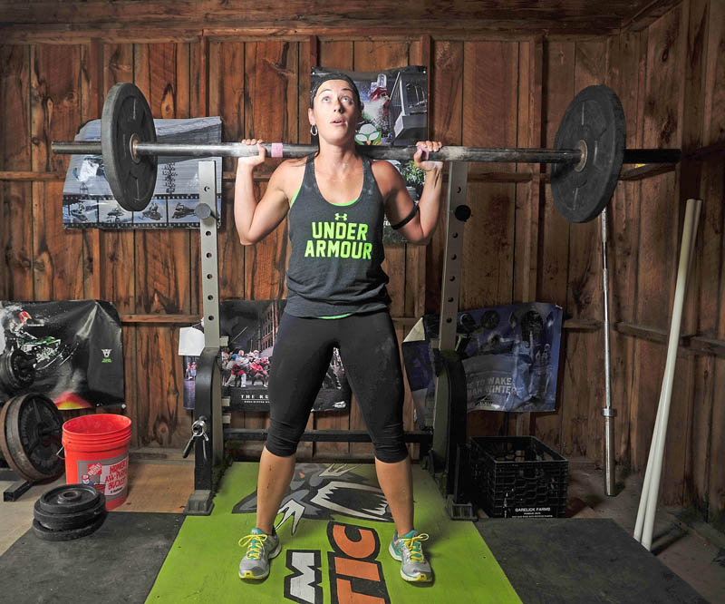 WORKING HARD: Holly MacKenzie, winner of the Under Armor “What’s Beautiful” contest, works out in her gym in the garage at her Oakland residence on Tuesday.