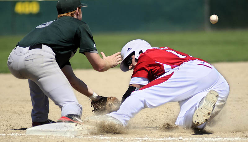 SAFE AT THIRD: The Red Barn’s Jory Humphrey slides under a throw to Pastime’s Ryan Riordan at third base during the American Legion state tournament Wednesday in Augusta.