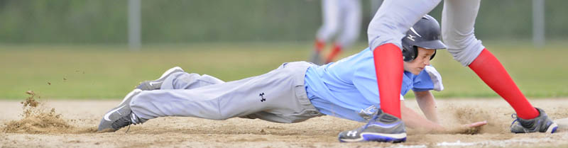 GET BACK: Central Maine’s Tyler Lewis slides safely into first base during a 13-year-old Babe Ruth state tournament game against Auburn on Sunday in Augusta. Central Maine won 11-6 to win the state title.