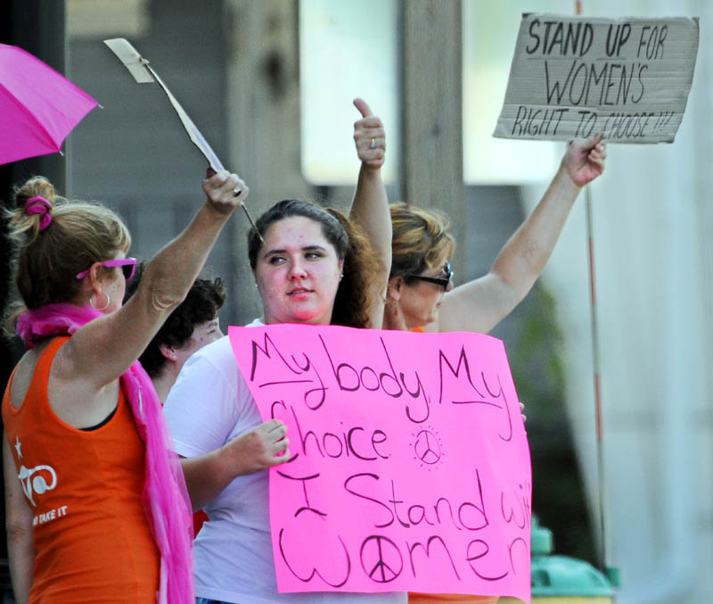 Members of Code Pink picket Monday on Memorial Drive in Augusta to raise awareness about reproductive rights.