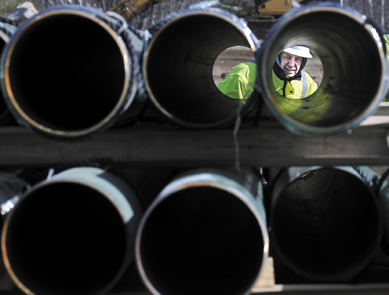 Rick Bellemare inspects a steel pipe delivered to the Windsor laydown yard of Maine Natural Gas earlier this year. The firm has reached an agreement with the University of Maine at Augusta to provide the school with natural gas for five years.