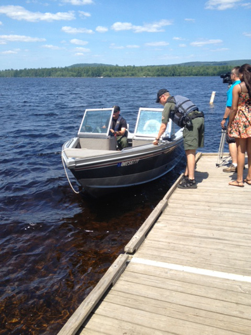 Wardens and divers search Great Moose Lake in Hartland for missing fisherman William Witt, 66, of Harmony.