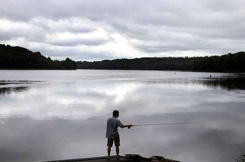 Mathias Deming, of Winthrop, casts today on the Kennebec River in Hallowell while fishing a buddy. The anglers reported catching a few bass while fly fishing together.