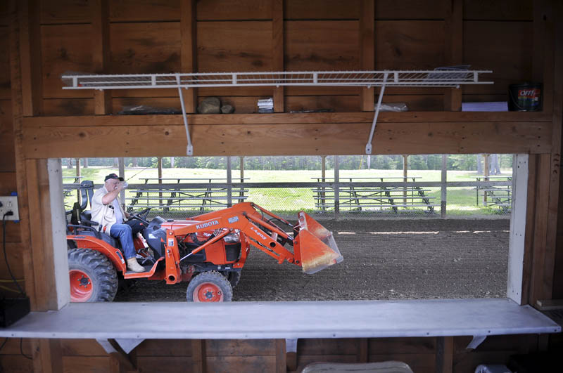 Duddy Brown grades the soil in the Greg Baker Pulling Ring at the Pittston faiground on Sunday. Several volunteers are preparing the fairground for the annual agricultural exhibition, which is scheduled to commence Thursday and wrap up Sunday.