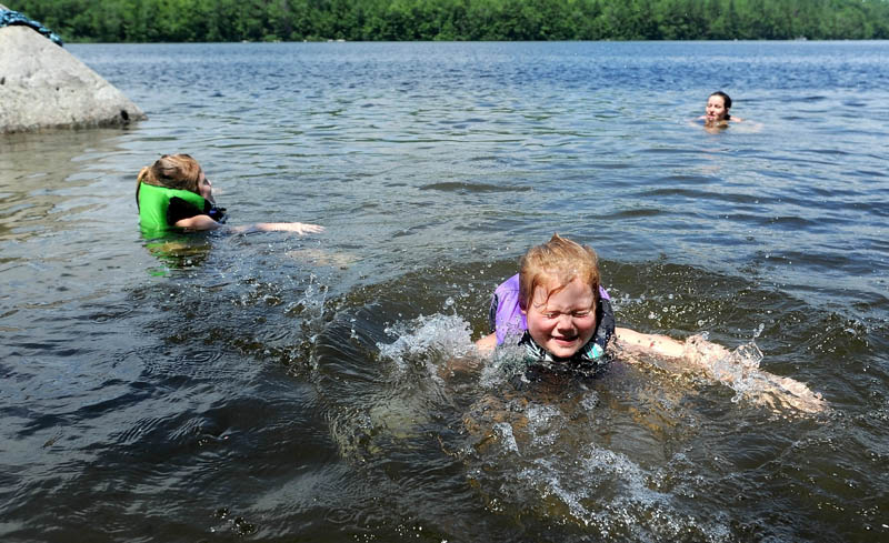 Willow Page, 5, front, sister, Daisy, 6, left, and mother, Mary-Anna, all of Anson, escape the high temperatures in Lake George, on the Canaan and Skowhegan town line, on Friday.