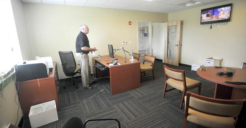 Waterville Police chief, Joseph Massey, settles in to his office at the new police station on Colby Circle on Thursday.