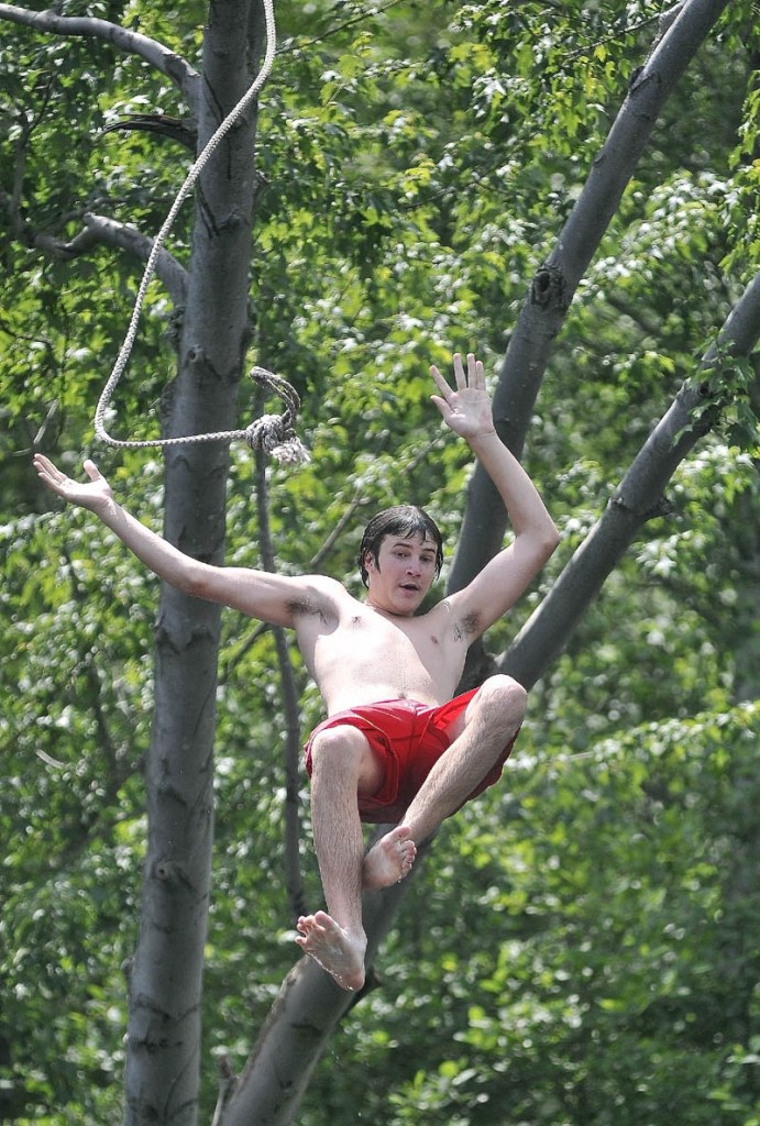 Kenneth Frappier, 15, of Fairfield, takes the plunge from a rope swing in to the Messalonskee Stream in Waterville near North Street on Saturday.