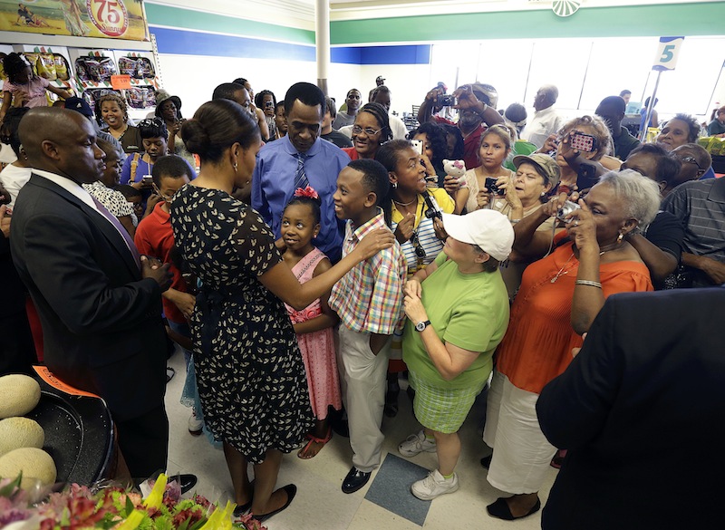 First lady Michelle Obama greets customers at Sterling Farms Grocery Store in Marrero, La., Tuesday, July 23, 2013. The store was opened last year by actor Wendell Pierce as part of the "Alliance For A Healthier Generation." Earlier she spoke about childhood obesity at the annual meeting of the National Council of La Raza. (AP Photo/Gerald Herbert)