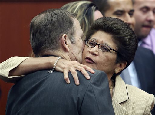 George Zimmerman's parents, Robert Zimmerman Sr. and Gladys Zimmerman, embrace following George Zimmerman's not guilty verdict in Seminole Circuit Court in Sanford, Fla., tonight.