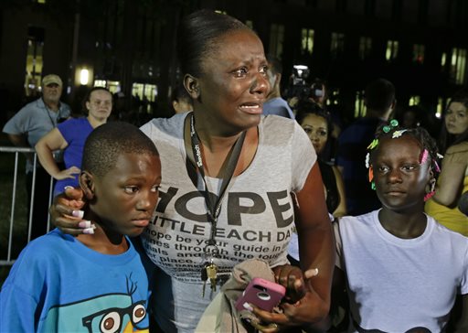 Darrsie Jackson, center, reacts after hearing the verdict of not guilty in the trial of George Zimmerman with her children, Linzey Stafford, left, 10, and Shauntina Stafford, 11, at the Seminole County Courthouse in Sanford, Fla., tonight.