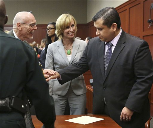 George Zimmerman, right, is congratulated by his defense team after being found not guilty during Zimmerman's trial in Seminole circuit court in Sanford, Fla. tonight. Jurors found Zimmerman not guilty of second-degree murder in the fatal shooting of 17-year-old Martin in Sanford, Fla. The six-member, all-woman jury deliberated for more than 15 hours over two days before reaching their decision.